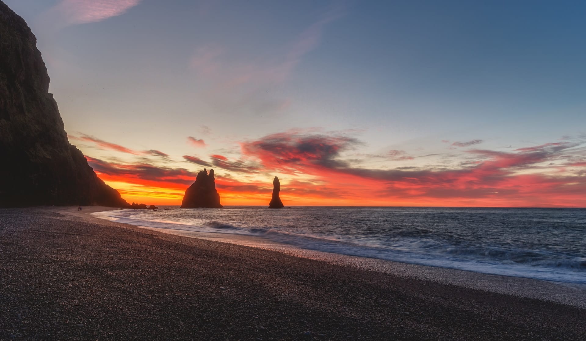 Sunset in Reynisfjara beach and Reynisdrangar sea columns in the distance at sunset.Iceland